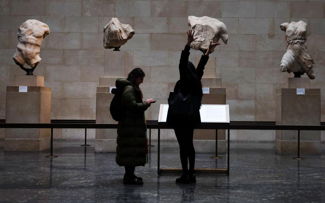 Visitors look at the marbles in the British Museum