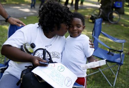 Protestor Irene Robinson (L) gets a hug from Terris Joshua outside Walter H. Dyett high school on the 11th day of her hunger strike in Chicago, Illinois, United States, August 27, 2015. REUTERS/Jim Young