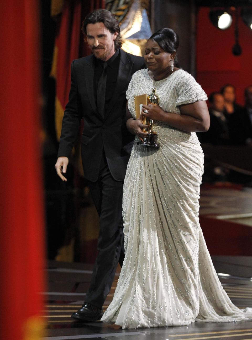 Octavia Spencer leaves the stage after accepting the Oscar for best actress in a supporting role for "The Help" during the 84th Academy Awards on Sunday, Feb. 26, 2012, in the Hollywood section of Los Angeles. At left is presenter Christian Bale. (AP Photo/Chris Carlson)