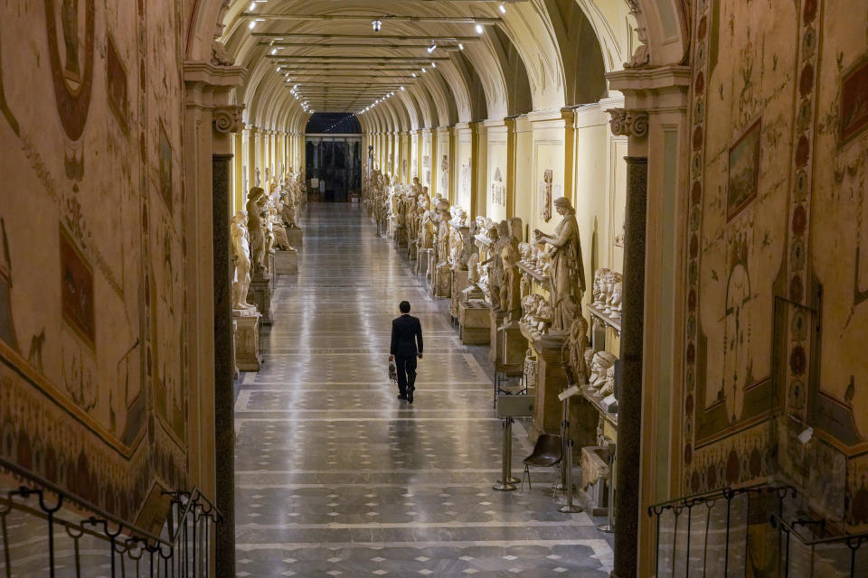 Gianni Crea, the Vatican Museums chief "Clavigero" key- keeper, walks down an aisle on his way to open the museum's rooms and sections, the Vatican, Monday, Feb. 1, 2021. Crea is the “clavigero” of the Vatican Museums, the chief key-keeper whose job begins each morning at 5 a.m., opening the doors and turning on the lights through 7 kilometers of one of the world's greatest collections of art and antiquities. The Associated Press followed Crea on his rounds the first day the museum reopened to the public, joining him in the underground “bunker” where the 2,797 keys to the Vatican treasures are kept in wall safes overnight. (AP Photo/Andrew Medichini)