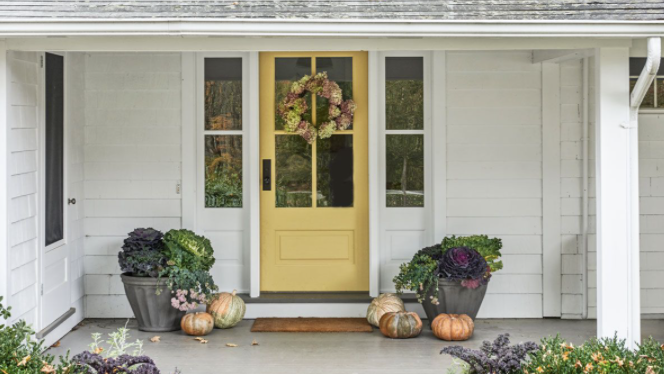 front porch decorated with fall pumpkins