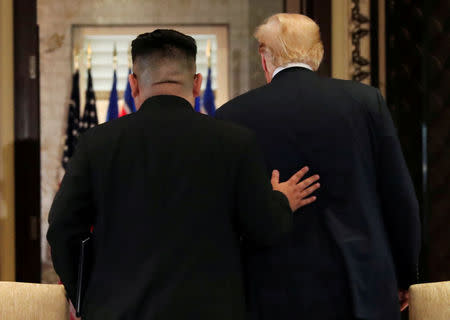 U.S. President Donald Trump and North Korea's leader Kim Jong Un leave after signing documents that acknowledge the progress of the talks and pledge to keep momentum going, after their summit at the Capella Hotel on Sentosa island in Singapore June 12, 2018. REUTERS/Jonathan Ernst/Files