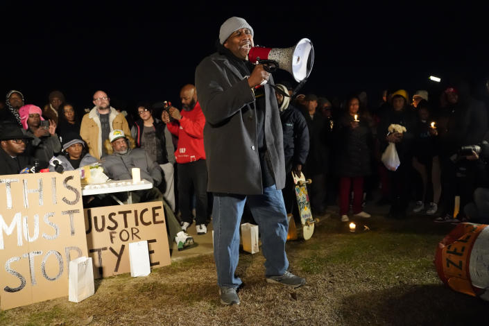 Rev. Andre E Johnson, of the Gifts of Life Ministries, preaches at a candlelight vigil for Tyre Nichols, who died after being beaten by Memphis police officers, in Memphis, Tenn., Thursday, Jan. 26, 2023. Behind at left are Tyre's mother RowVaughn Wells and his stepfather Rodney Wells. (AP Photo/Gerald Herbert)