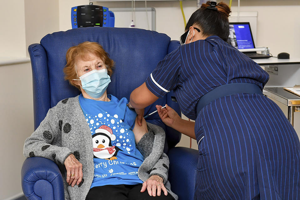 90 year old Margaret Keenan, the first patient in the UK to receive the Pfizer-BioNTech COVID-19 vaccine, administered by nurse May Parsons at University Hospital, Coventry, England, Tuesday Dec. 8, 2020.