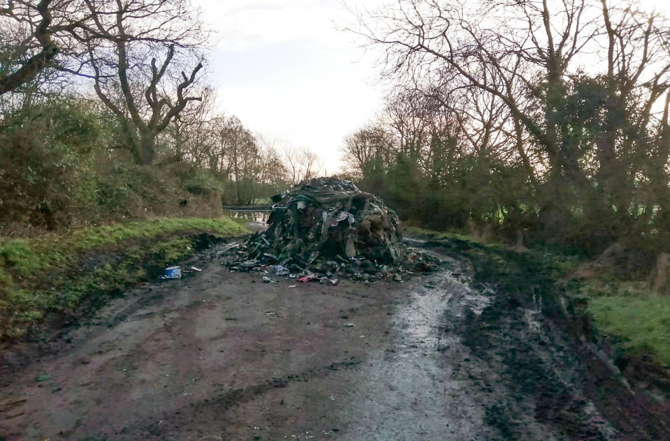 The charred rubbish has blocked the entire length of the lane (Picture: SWNS)