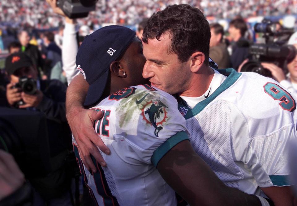 12302000 Pro Player Stadium... Dolphins vs Colts.....Dolphins QB Jay Fiedler gives WR O.J. McDuffie a hug following the Dolphins overtime win against the Colts. Dolphins win 23-17 in first playoff game. Staff photo by Allen Eyestone ORG XMIT: MER0701310952280703