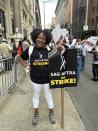 Actor Autumn Monroe poses on a picket line in New York on Aug. 24, 2023. Monroe is one of thousands of entertainment industry workers forced by the Hollywood contract fights to find outside work. (Leanne Italie via AP)