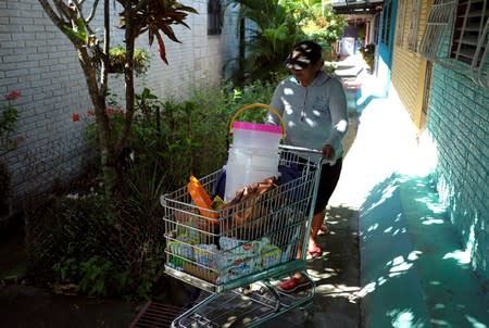 A vendor walks by the house of Rosa Ramirez in San Martin