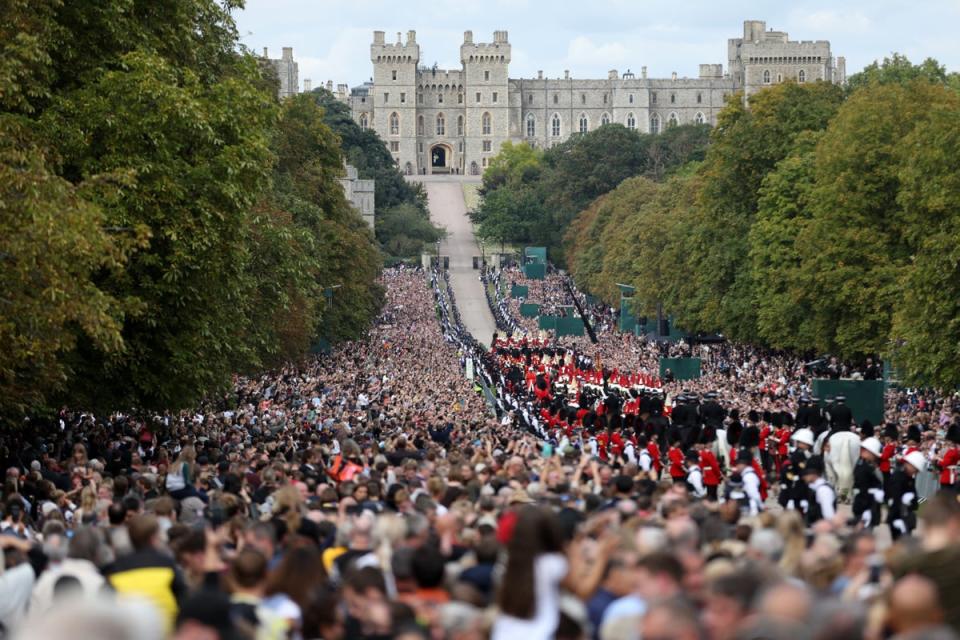 Mourners watch the Royal Hearse as it drives along Windsor Castle’s Long Walk ahead of the committal service (Getty Images)