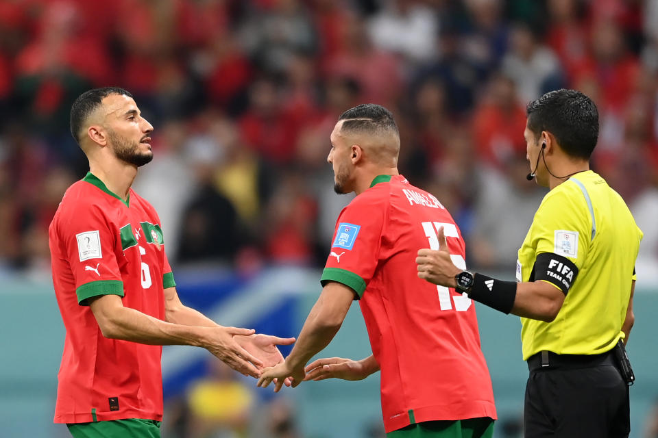 Pictured left, Morocco captain Romain Saiss goes off with injury midway through the first half of the world Cup semi-final against France. 
