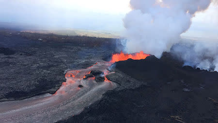 FILE PHOTO: Lava fragments falling from lava fountains at fissure 8 are building a cinder-and-spatter cone around the erupting vent, with the bulk of the fragments falling on the downwind side of the cone as it continues to feed a channelized lava flow that reaches the ocean at Kapoho during ongoing eruptions of the Kilauea Volcano in Hawaii, U.S. June 11, 2018. USGS/Handout via REUTERS