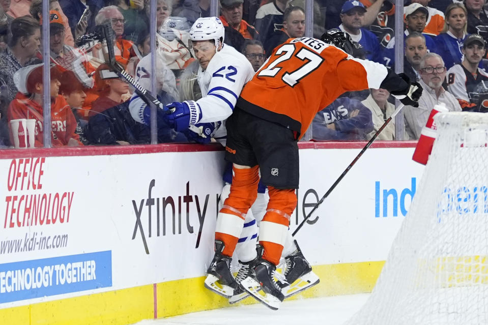 Toronto Maple Leafs' Jake McCabe, left, and Philadelphia Flyers' Noah Cates collide during the second period of an NHL hockey game, Thursday, March 14, 2024, in Philadelphia. (AP Photo/Matt Slocum)
