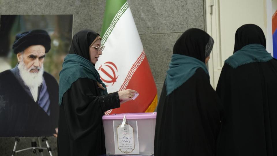 A woman votes at a polling station at the Iranian embassy in Baghdad