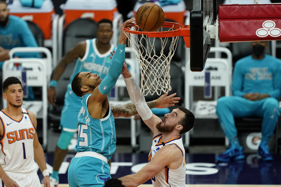 Charlotte Hornets forward P.J. Washington is fouled by Phoenix Suns forward Frank Kaminsky, right, during the first half of an NBA basketball game, Wednesday, Feb. 24, 2021, in Phoenix. (AP Photo/Matt York)