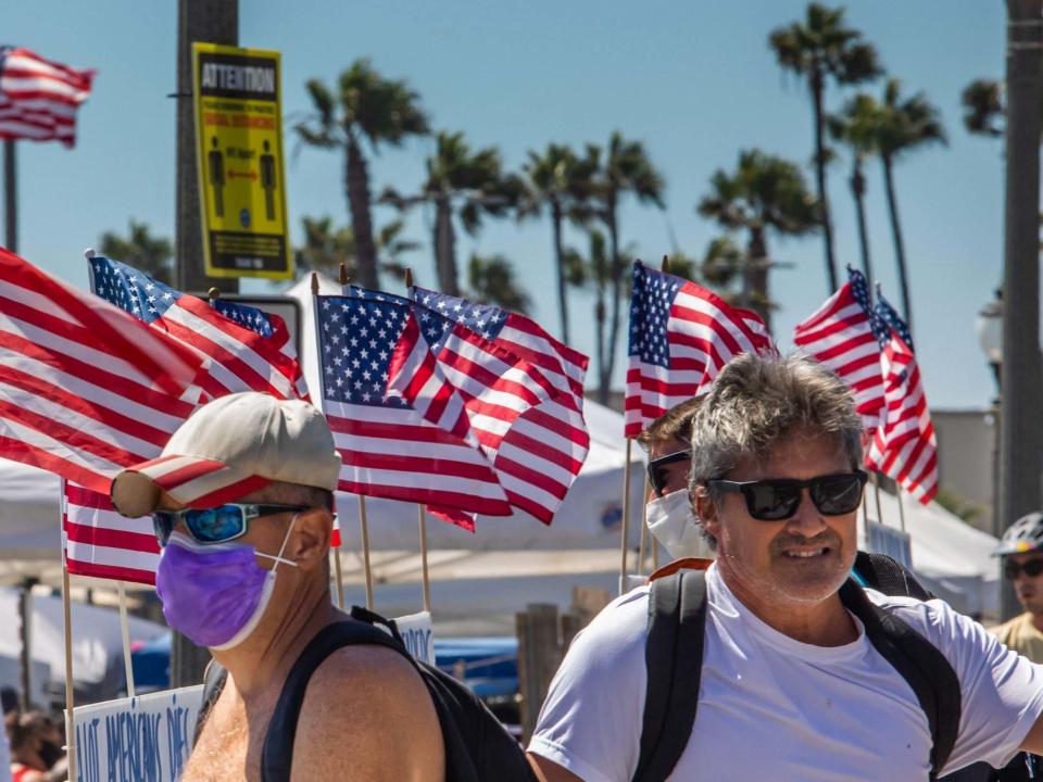 People cross the street in Huntington Beach, California, on July 19, 2020 amid the coronavirus pandemic: AFP via Getty Images