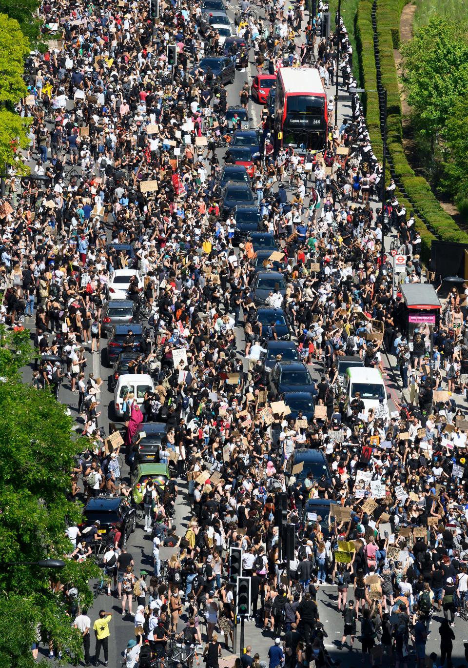 Demonstrators block the road as they gather outside the US Embassy in London on May 31, 2020 to protest the death of George Floyd, an unarmed black man who died after a police officer knelt on his neck for nearly nine minutes during an arrest in Minneapolis, USA. - Hundreds gathered in central London and marched to teh US Embassy to protest the death of an unarmed black man in Minneapolis while in police custody that has sparked days of unrest in the US city and beyond. (Photo by JUSTIN TALLIS / AFP) / The erroneous mention[s] appearing in the metadata of this photo by JUSTIN TALLIS has been modified in AFP systems in the following manner: [London] instead of [Brighton]. Please immediately remove the erroneous mention[s] from all your online services and delete it (them) from your servers. If you have been authorized by AFP to distribute it (them) to third parties, please ensure that the same actions are carried out by them. Failure to promptly comply with these instructions will entail liability on your part for any continued or post notification usage. Therefore we thank you very much for all your attention and prompt action. We are sorry for the inconvenience this notification may cause and remain at your disposal for any further information you may require. (Photo by JUSTIN TALLIS/AFP via Getty Images)