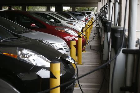 Electric cars sit charging in a parking garage at the University of California, Irvine January 26, 2015. REUTERS/Lucy Nicholson