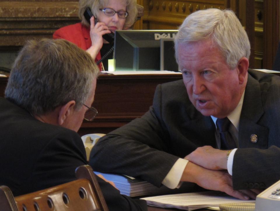 Kansas Senate President Steve Morris, right, a Hugoton Republican, confers with Sen. John Vratil, left, a Leawood Republican, during a session of the Senate, Tuesday, March 20, 2012, at the Statehouse in Topeka, Kan. The Senate has crafted its own alternative to Gov. Sam Brownback's plan to reduce income taxes. (AP Photo/John Hanna)