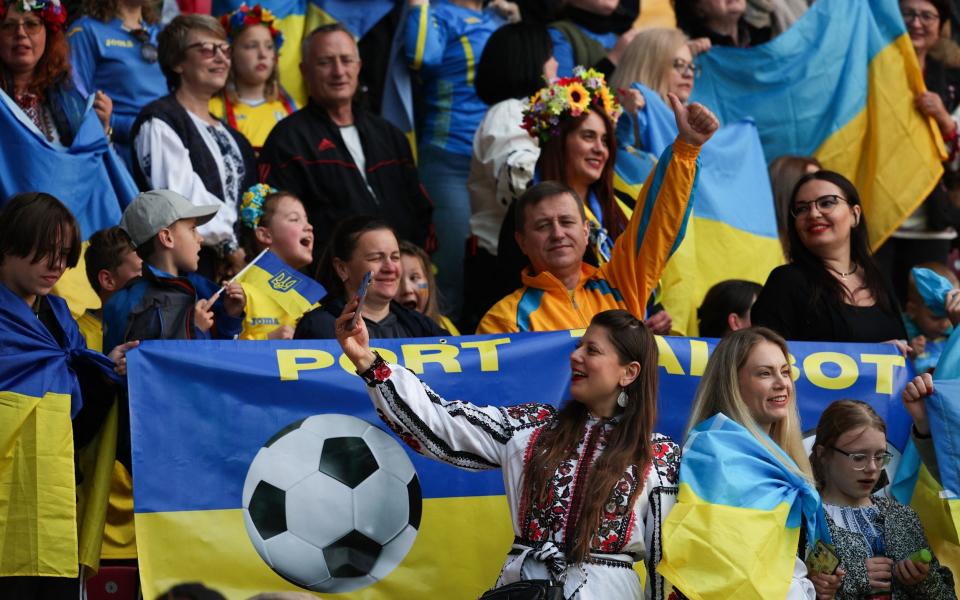 Ukrainian fans react in the stands during the UEFA Women's Euro 2025 League B Group 4 qualifying football match between Wales and Ukraine at Parc Y Scarlets stadium in Llanelli, Wales, on May 31, 2024