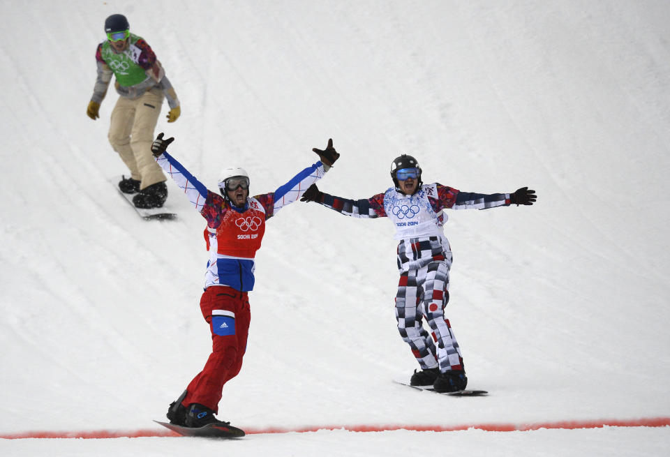 France's Pierre Vaultier (L) and Russia's Nikolay Olyunin cross the finish line in the Men's Snowboard Cross Final at the Rosa Khutor Extreme Park during the Sochi Winter Olympics on February 18, 2014.     AFP PHOTO / LIONEL BONAVENTURE        (Photo credit should read LIONEL BONAVENTURE/AFP/Getty Images)