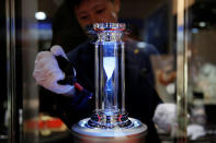 A Rainbow Diamond LLC employee cleans a diamond-filled hourglass that totals to 100 carats, at the International Jewellery Tokyo trade show in Tokyo, Japan January 24, 2017. REUTERS/Toru Hanai