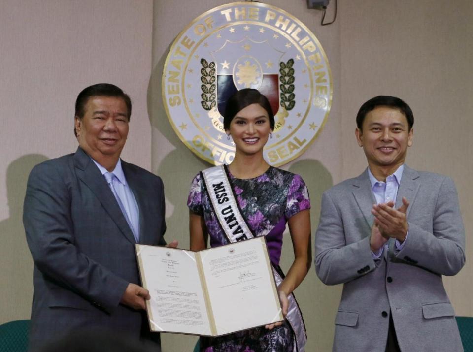 Newly crowned Miss Universe Pia Alonzo Wurtzbach is presented the Senate Resolution from Sen. President Franklin Drilon congratulating her for her victory in the 2015 Miss Universe during a ceremony Monday, Jan. 25, 2016 in Manila, Philippines. Wurtzbach was crowned Miss Universe Dec. 20, 2015 but not before pageant host Steve Harvey incorrectly announced Miss Colombia as the winner at the Miss Universe pageant in Las Vegas. At right is Sen. Sonny Angara. (AP Photo/Bullit Marquez)