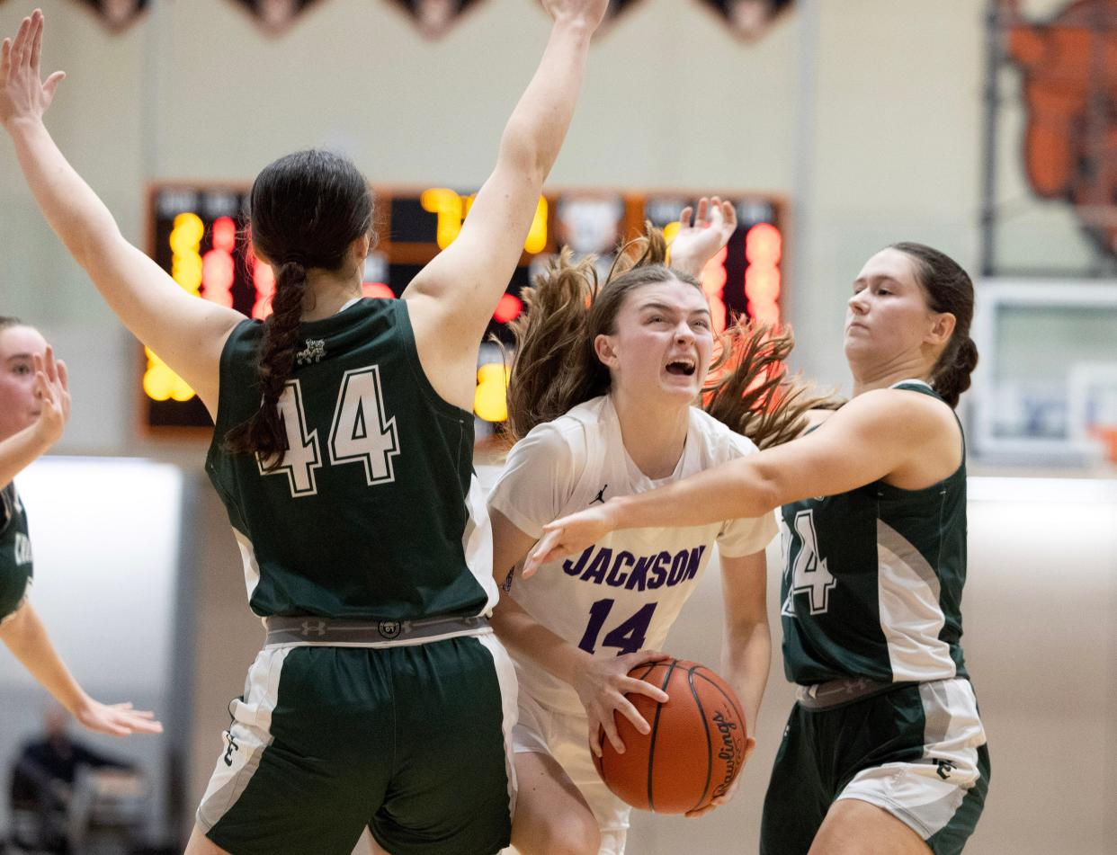 Jackson's Madison Lepley is defended by Central Catholic's Alicia Varacky (44) and Lily Belden (24) in the second half of Wednesday's game.