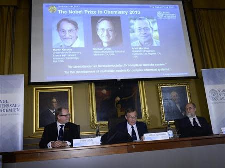 Chairman Sven Lidin (L-R), permanent secretary Staffan Normark and professor Gunnar Karlstrom of the Royal Swedish Academy of Sciences announce the winners of the 2013 Nobel Prize for Chemistry at the Royal Swedish Academy of Sciences in Stockholm October 9, 2013. REUTERS/Claudio Bresciani/TT News Agency