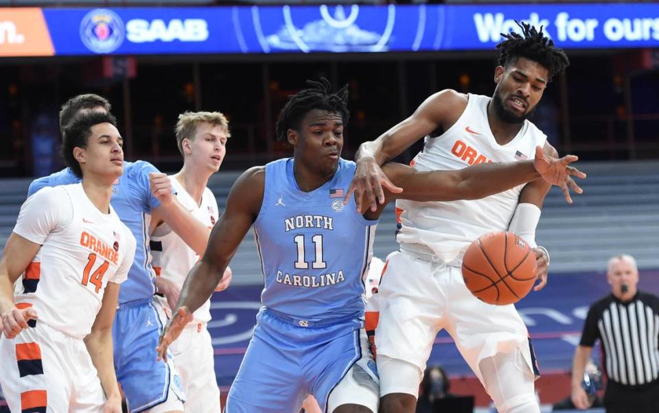 North Carolina Tar Heels forward Day’Ron Sharpe (11) and Syracuse Orange forward Quincy Guerrier (1) work on getting a loose ball rebound in a game between Syracuse and North Carolina at the Carrier Dome in Syracuse N.Y. March 1, 2021. Dennis Nett | dnett@syracuse.com