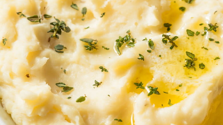 Garnished mashed potatoes slathered in butter