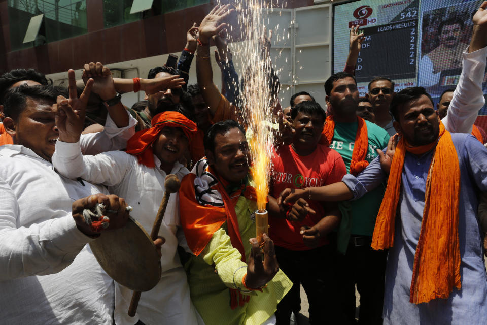 Bharatiya Janata Party (BJP) workers celebrate at BJP headquarters in, Lucknow, India, Thursday, May 23, 2019. Indian Prime Minister Narendra Modi and his party were off to an early lead as vote counting began Thursday following the conclusion of the country's 6-week-long general election, sending the stock market soaring in anticipation of another five-year term for the Hindu nationalist leader.(AP Photo/Rajesh Kumar Singh)