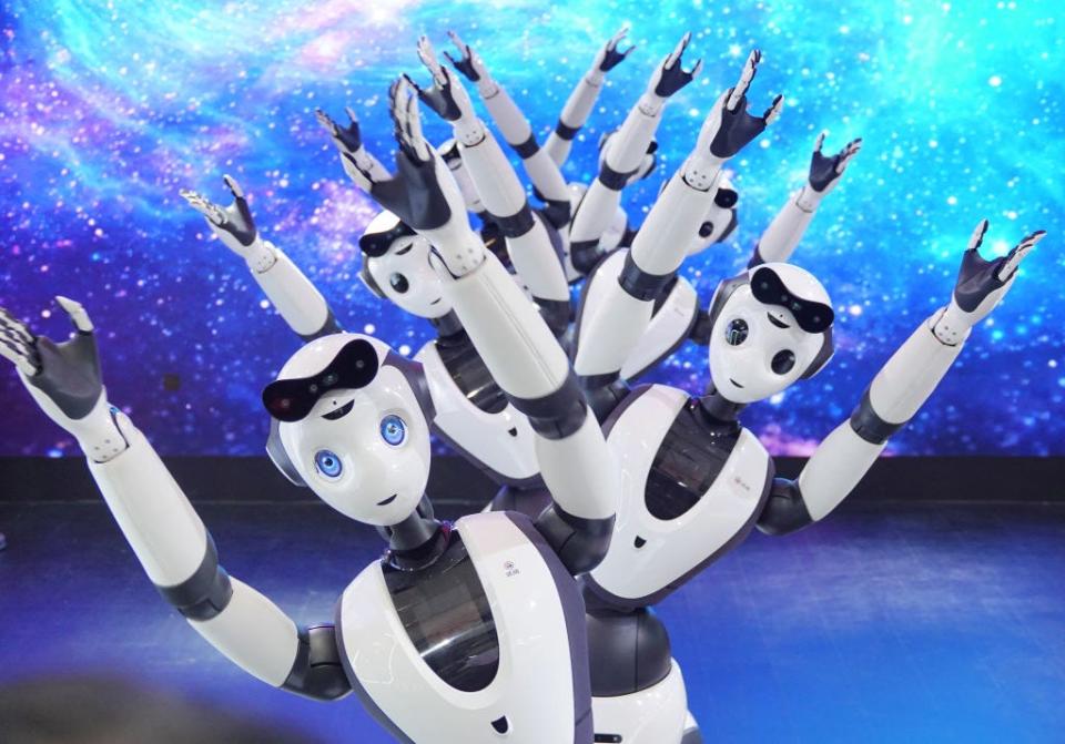 umanoid service robots dance at the booth of Dataa Robotics during 2023 World Robot Conference at Beijing Etrong International Exhibition & Convention Center on August 18, 2023.