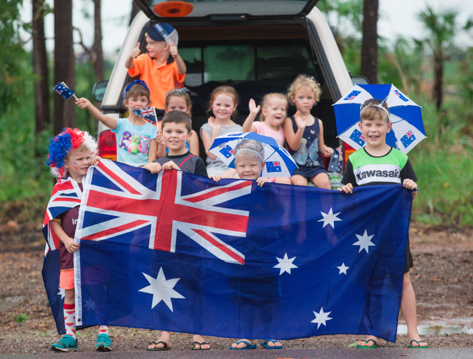 Participants are seen along the parade route during Australia Day Ute Run in Darwin.