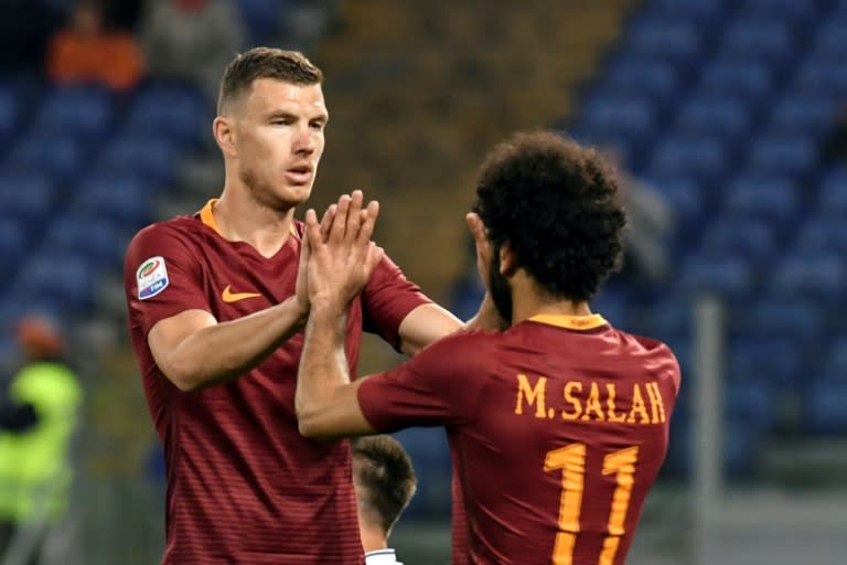 Roma's Bosnian forward Edin Dzeko (L) celebrates with teammate Mohamed Salah after scoring a goal against Empoli on April 1, 2017 at Rome's Olympic stadium