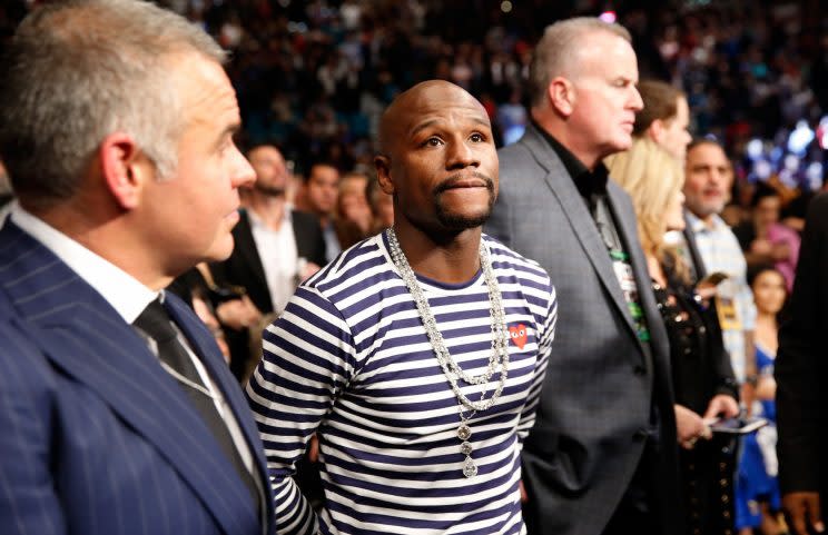 Floyd Mayweather (middle) attended the Carl Frampton-Leo Santa Cruz fight Saturday at the MGM Grand and appeared on the television broadcasts of the fight in the U.S. and the United Kingdom to express his interest in fighting UFC star Conor McGregor. (Getty Images)