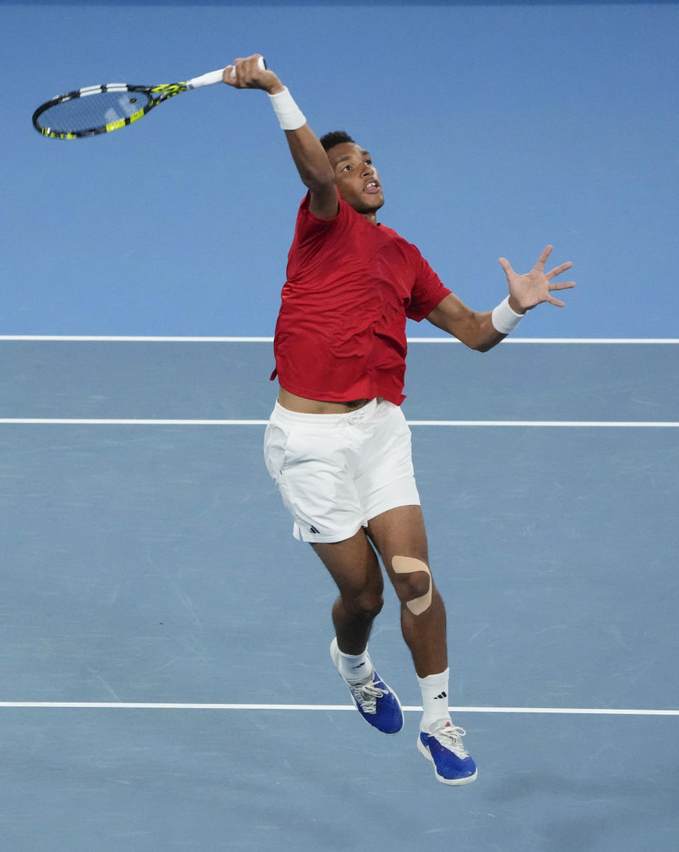 Canada's Felix Auger-Aliassime returns the ball during their United Cup doubles tennis match against Despina Papamichail of Greece and teammate Petros Tsitsipas in Sydney, Australia, Wednesday, Jan. 3, 2024. (AP Photo/Mark Baker)