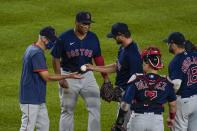 Boston Red Sox relief pitcher Colten Brewer hands the ball to manager Ron Roenicke, left, as he leaves during the third inning of a baseball game against the New York Yankees Friday, Aug. 14, 2020, in New York. (AP Photo/Frank Franklin II)