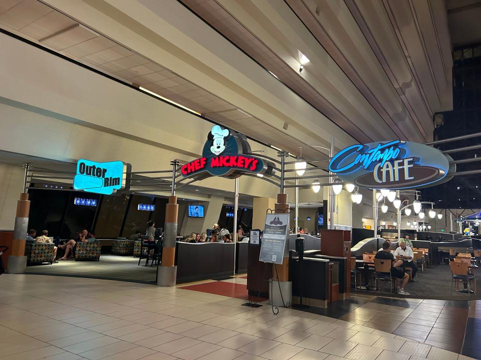 chef mickey and signs for two other restaurants in plain tiled area