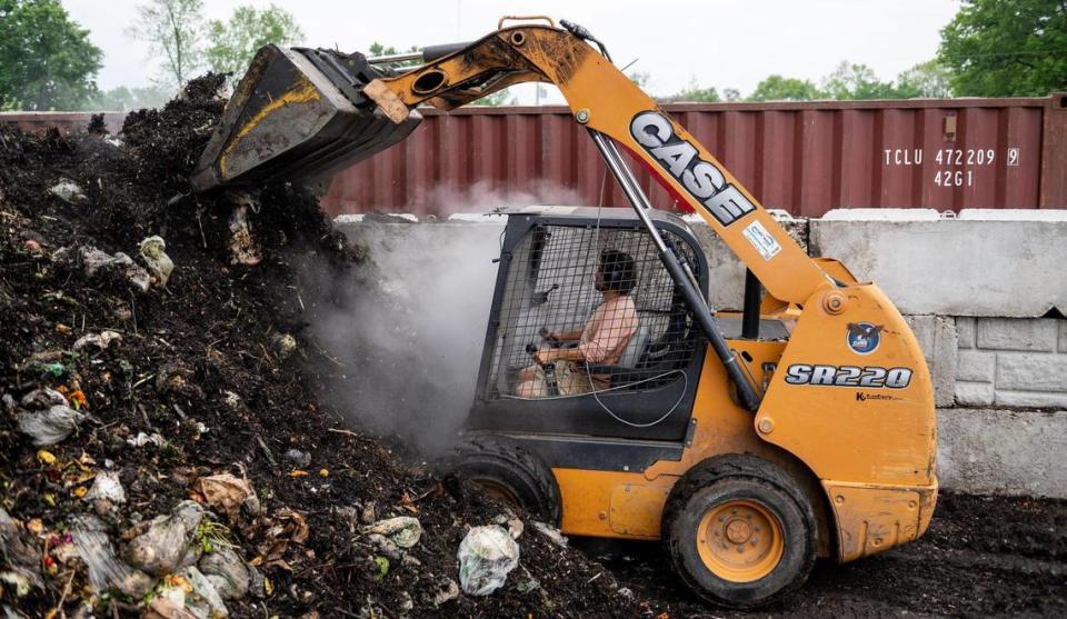 Dan Heryer uses a front loader to mix a pile of compost. He and his wife purchased Compost Collective KC in 2021 to expand their farm’s composting efforts.