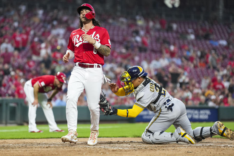 Cincinnati Reds' Jonathan India, left, is tagged out at home plate by Milwaukee Brewers' William Contreras during the sixth inning of a baseball game in Cincinnati, Monday, June 5, 2023. (AP Photo/Aaron Doster)