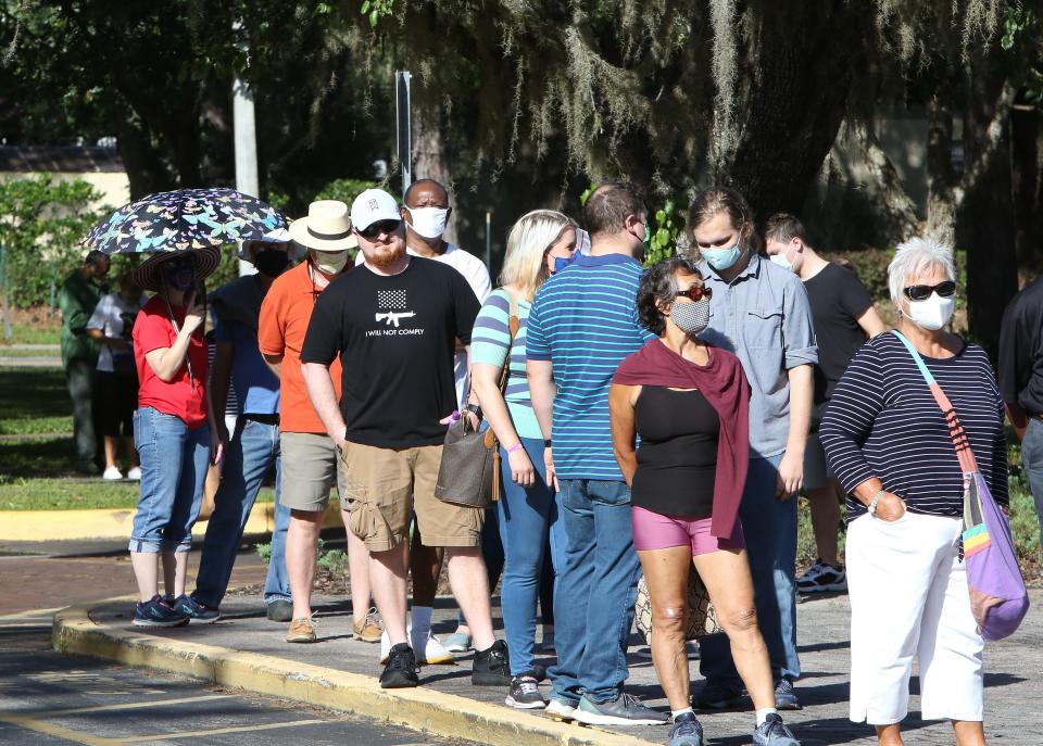 Residents wait in line to early vote in the 2020 presidential election at the Millhopper Branch of the Alachua County Library, in Gainesville on Oct. 19, 2020. Alachua County has six early voting locations that are open daily 9 a.m. to 6 p.m.