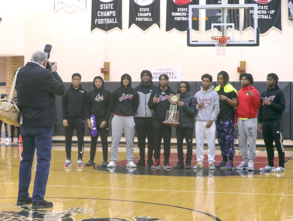 Buchtel High School boys basketball players are photographed by Bruce Ford during a school assembly celebrating the team's Division II state title, Wednesday, March 22, 2023.