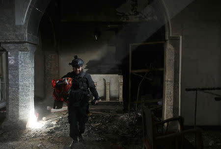 A Christian Iraqi special forces soldier walks in a church in Bartella, east of Mosul. REUTERS/Goran Tomasevic