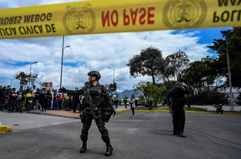 Colombian security forces stand guard outside a police cadet training academy in Bogota, the site of a deadly car bomb attack blamed on ELN rebels