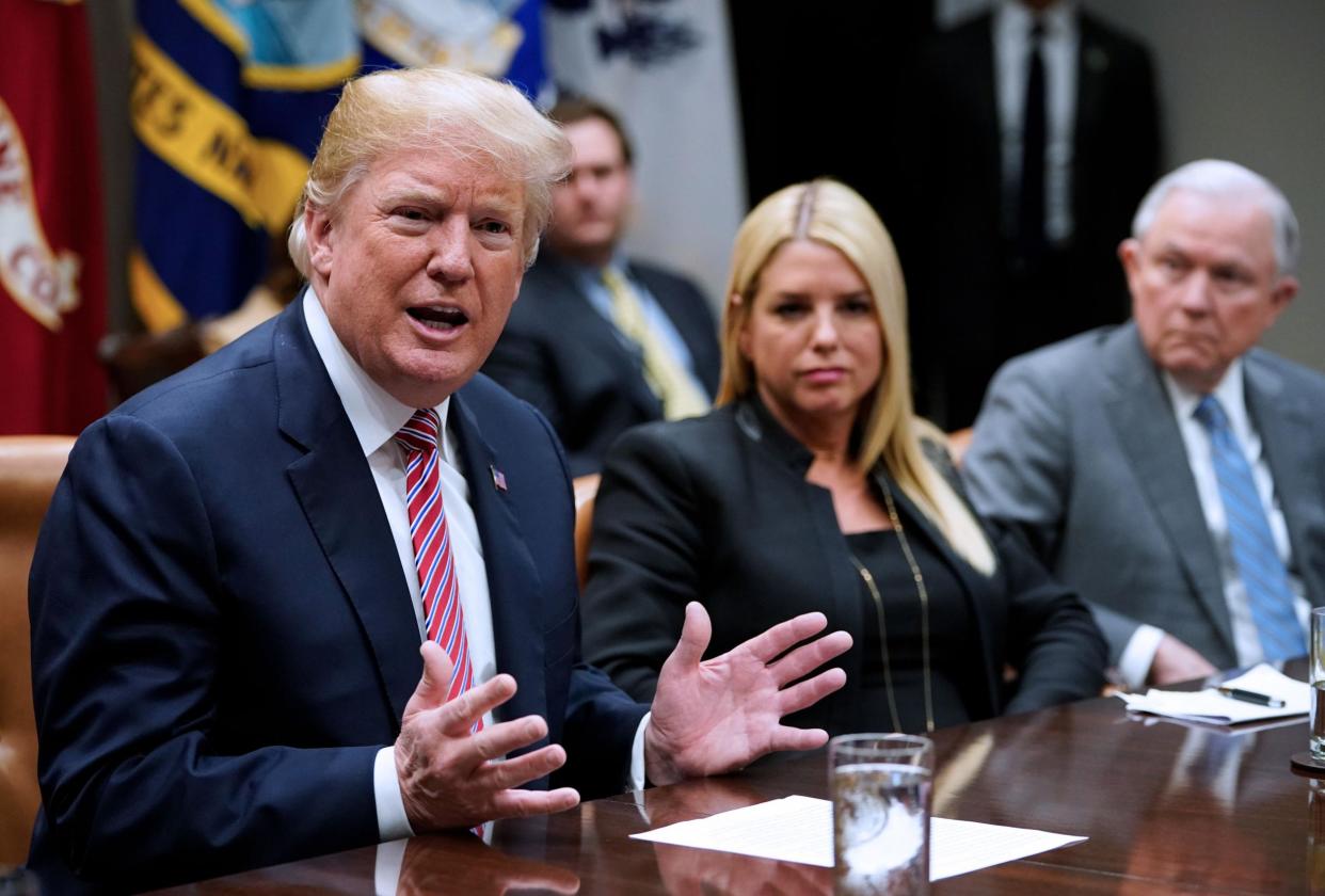 Mr Trump during a meeting at the White House alongside Florida Attorney General Pam Bondi and US Attorney General Jeff Sessions: AFP/Getty Images