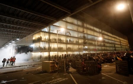 Protesters form barricades as they demonstrate at the airport, after a verdict in a trial over a banned independence referendum, in Barcelona