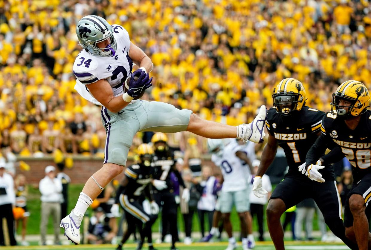 Sep 16, 2023; Columbia, Missouri, USA; Kansas State Wildcats tight end Ben Sinnott (34) scores a touchdown against Missouri Tigers defensive back Jaylon Carlies (1) and defensive back Joseph Charleston (28) during the second half at Faurot Field at Memorial Stadium. Mandatory Credit: Jay Biggerstaff-USA TODAY Sports