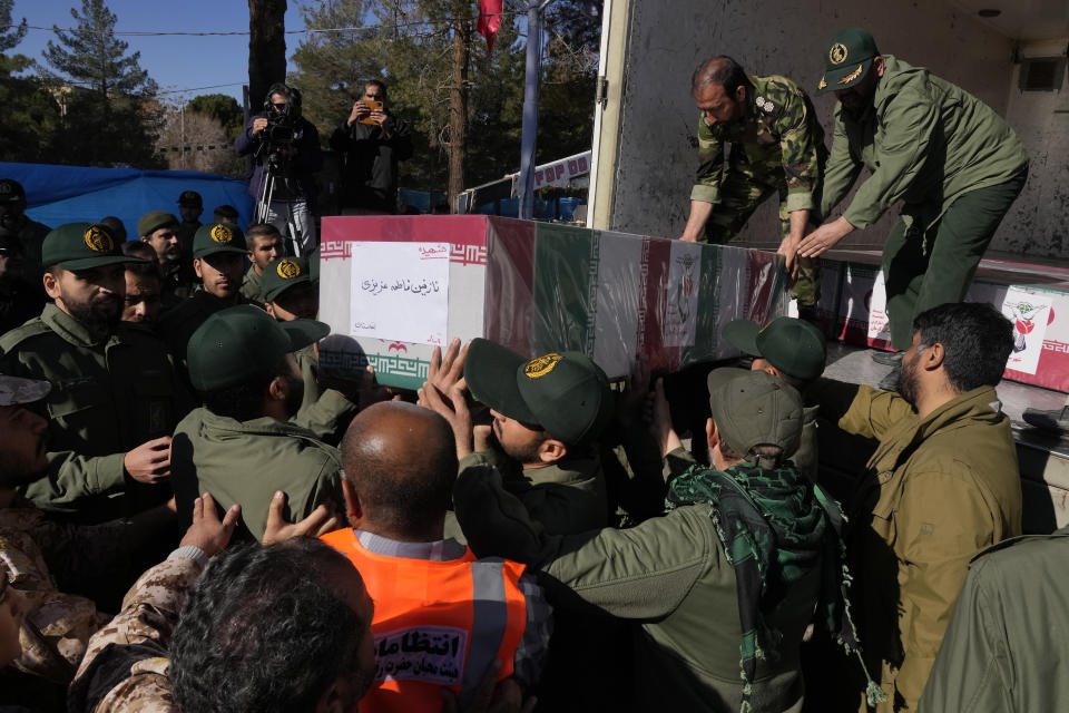 Revolutionary Guard members carry the Iranian flag-draped coffin of Nazanin Fatemeh Azizi, a 4-year old girl from Afghanistan, who was killed in Wednesday's bomb explosion, during the victims funeral ceremony in the city of Kerman about 510 miles (820 km) southeast of the capital Tehran, Iran, Friday, Jan. 5, 2024. Iran on Friday mourned those slain in an Islamic State group-claimed suicide bombing targeting a commemoration for a general slain in a U.S. drone strike in 2020. (AP Photo/Vahid Salemi)