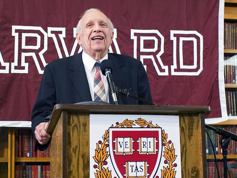 Nobel Prize winner Roy J. Glauber stands in behind a podium and in front of a Harvard banner at Harvard University on October 4, 2005