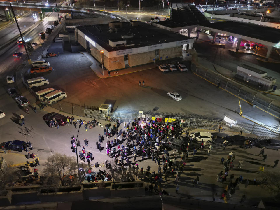 People take part in a vigil for the victims of a fire at an immigration detention center that killed dozens, in Ciudad Juarez, Mexico, Tuesday, March 28, 2023. According to Mexican President Andres Manuel Lopez Obrador, migrants fearing deportation set mattresses ablaze at the center, starting the fire. (AP Photo/Christian Chavez)